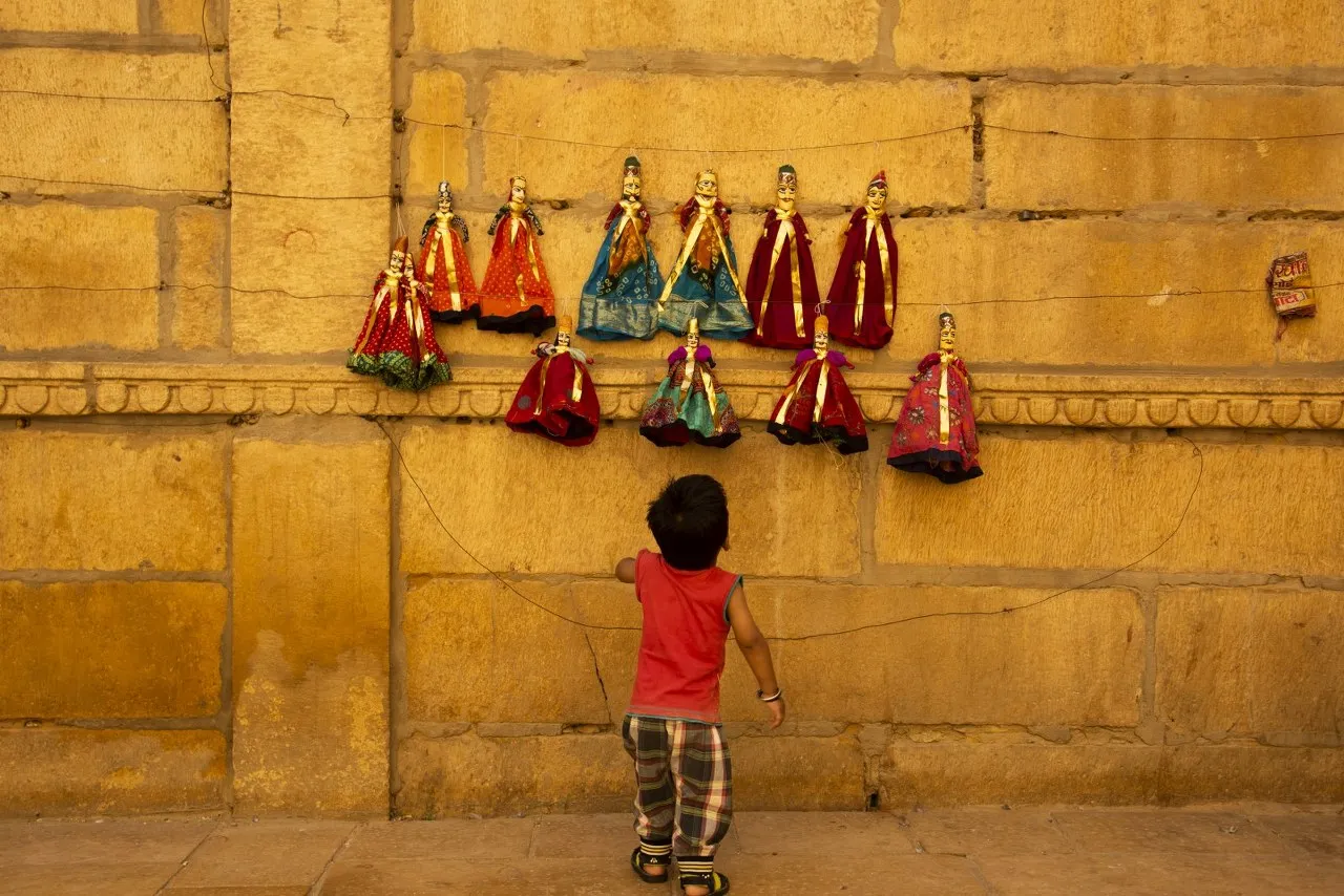 Child enjoying traditional puppet culture in Jaisalmer